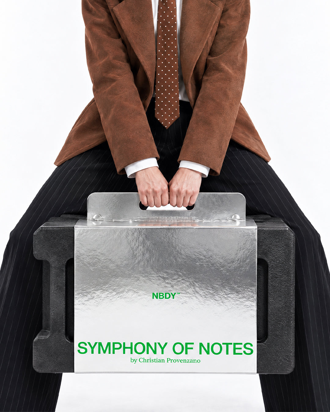Model seated with the Symphony of Notes Block case on her knees