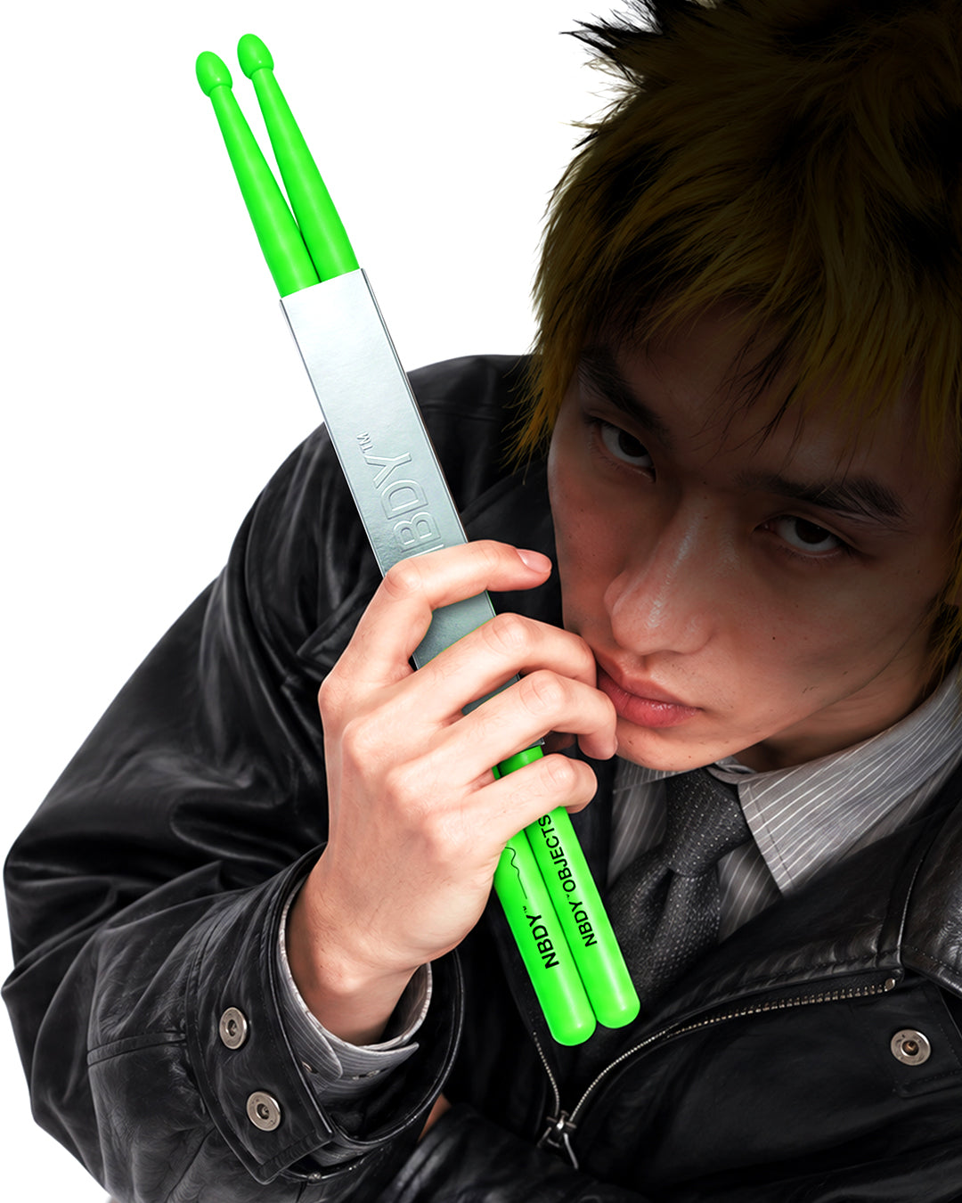 Model holding a pair of NBDY drumsticks to his face