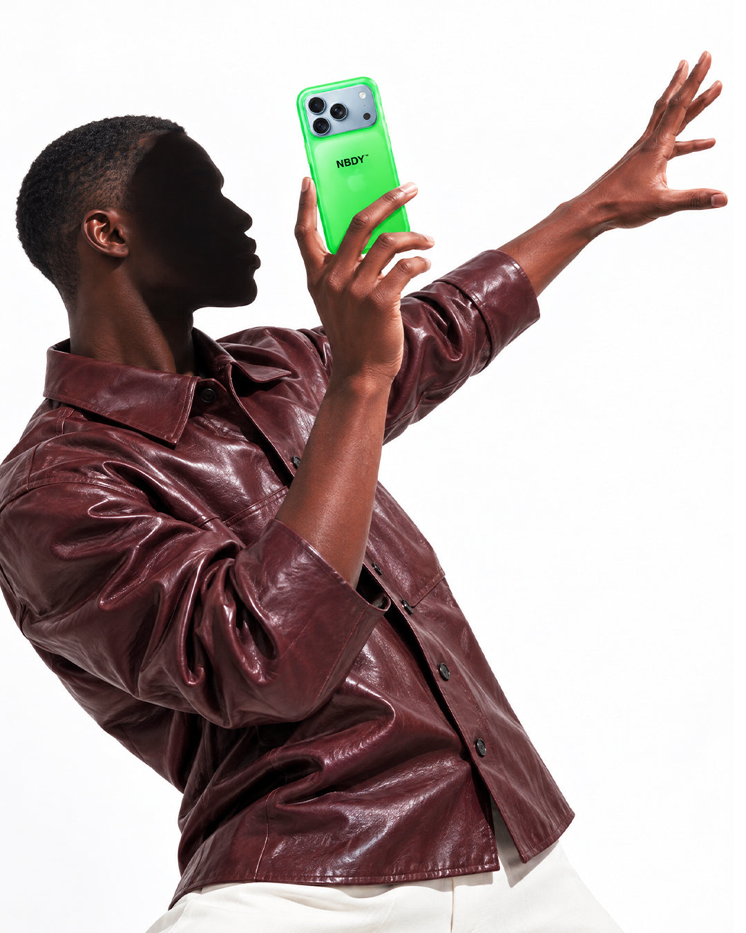 Model dancing with an iPhone in the NBDY case held up